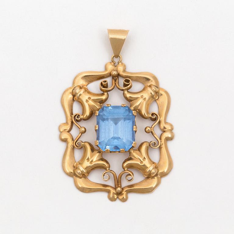 A pendant set with synthetic, blue spinel.