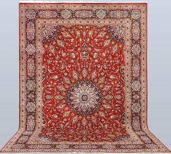 A Keshan carpet, part silk, signed, approx. 398 x 270 cm.