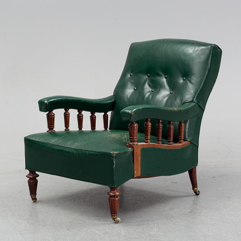 An early 20th Century easy chair with leather upholstery.