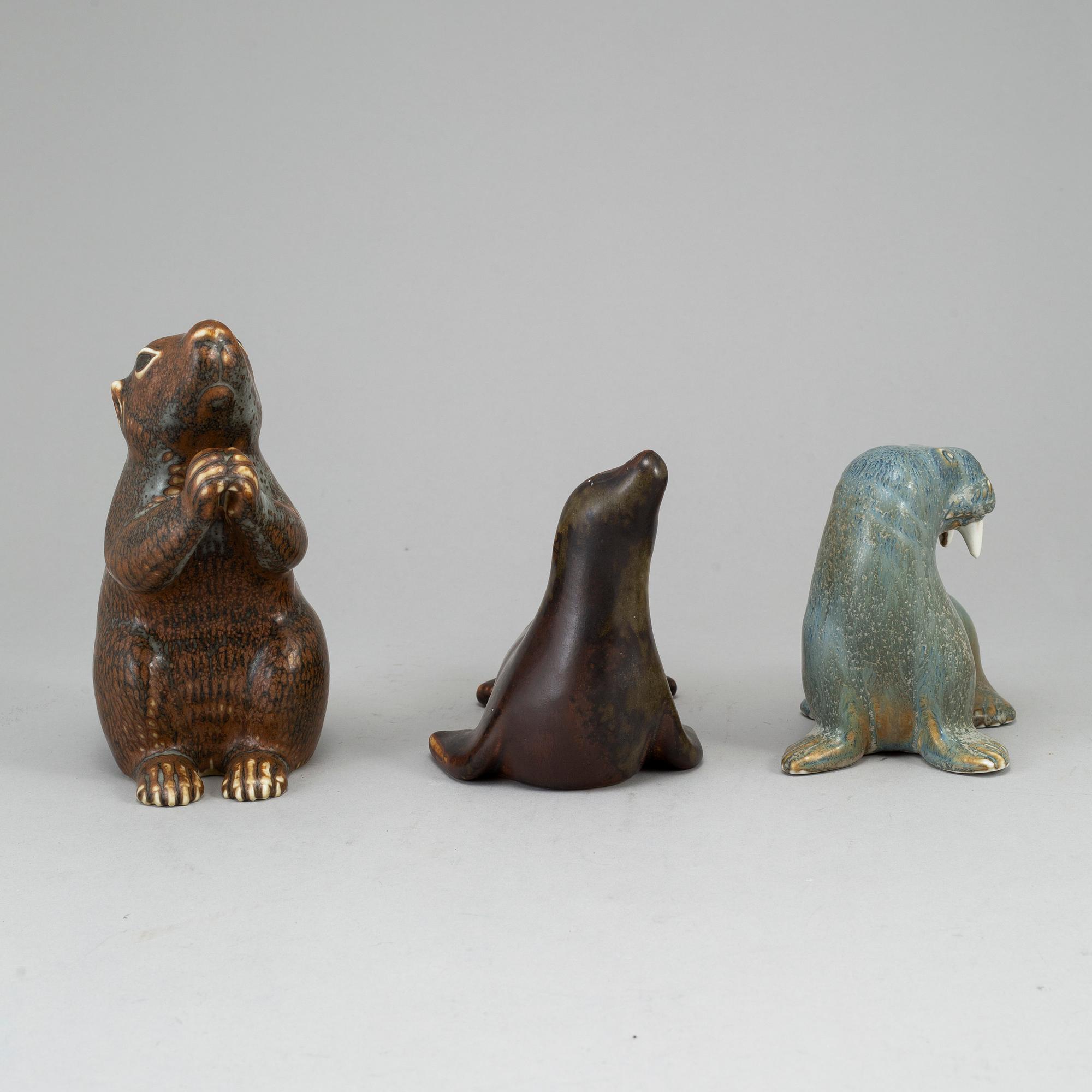 GUNNAR NYLUND, a set of thre stoneware sculptures; a squirrel, a walrus and a seal, Rörstrand, Sweden.