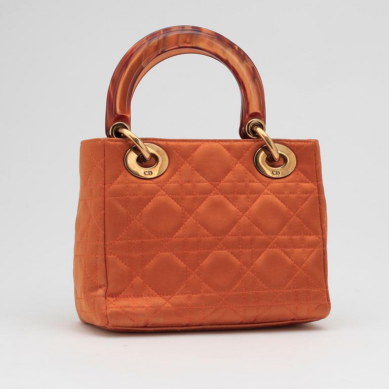 CHRISTIAN DIOR, an orange silk handbag.