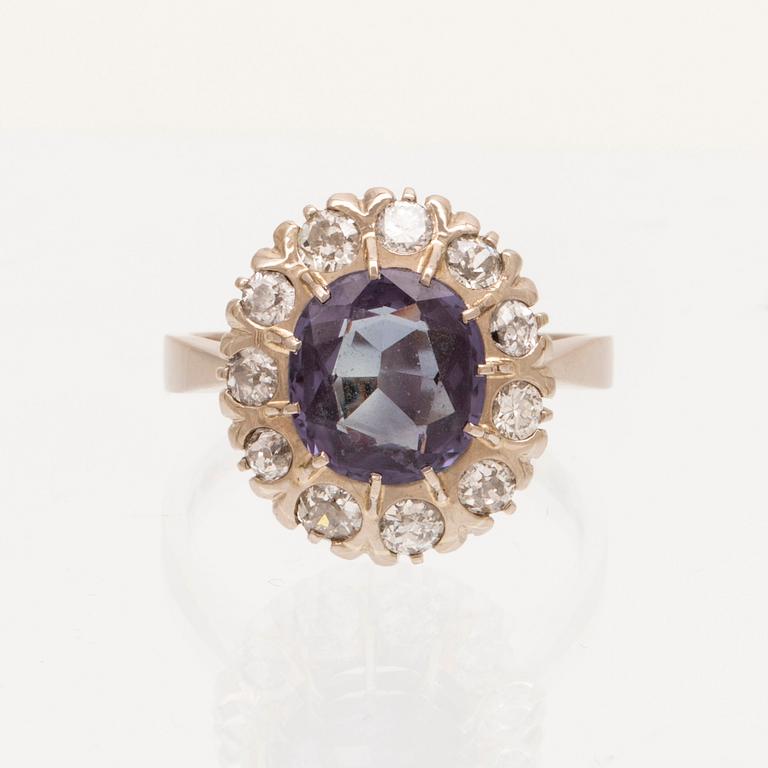 An 18K white gold ring with a colour change synthetic purple sapphire and brilliant and old cut diamonds.