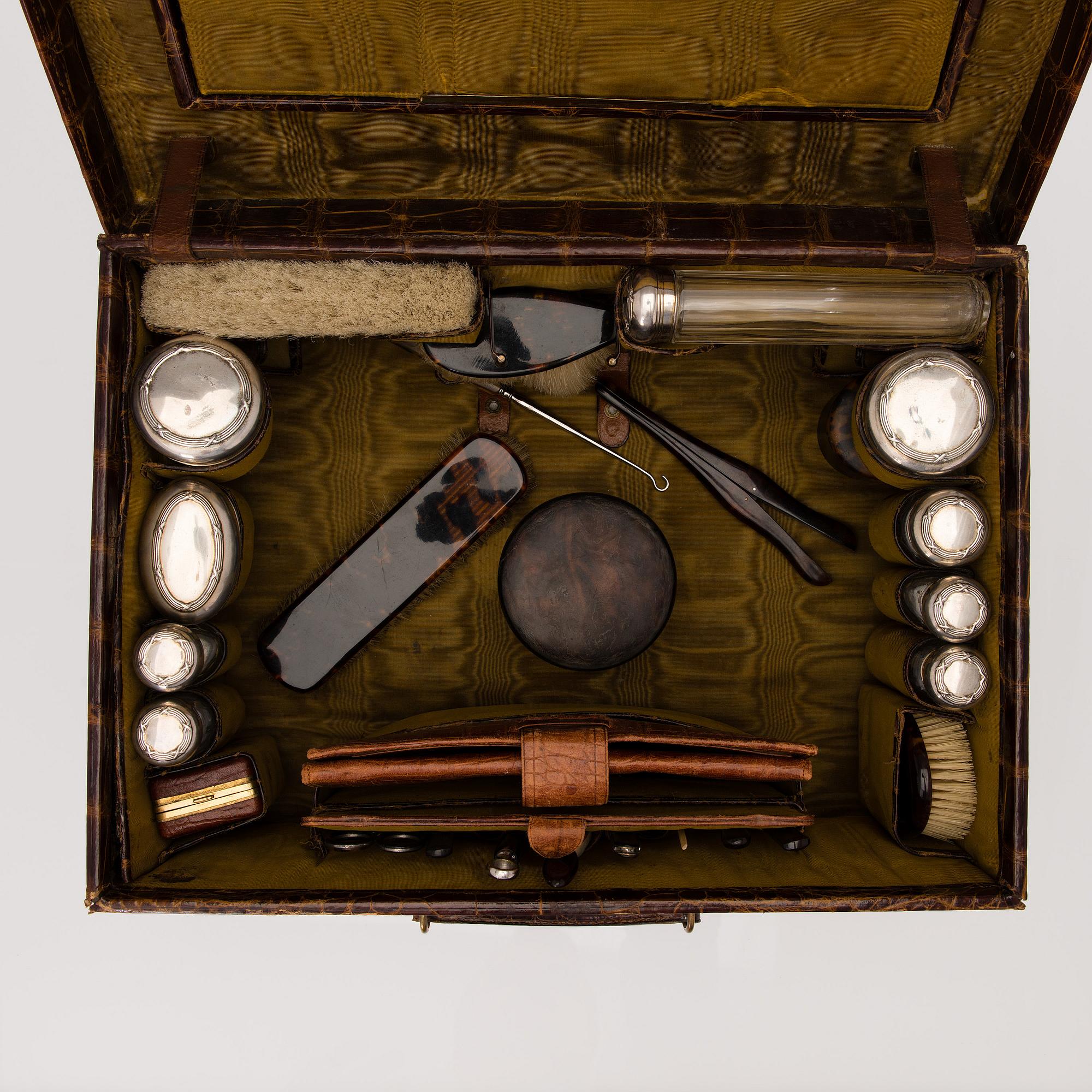 A TRAVEL TOILET CASE, leather, German 1910-20s, boxes with silver lid.