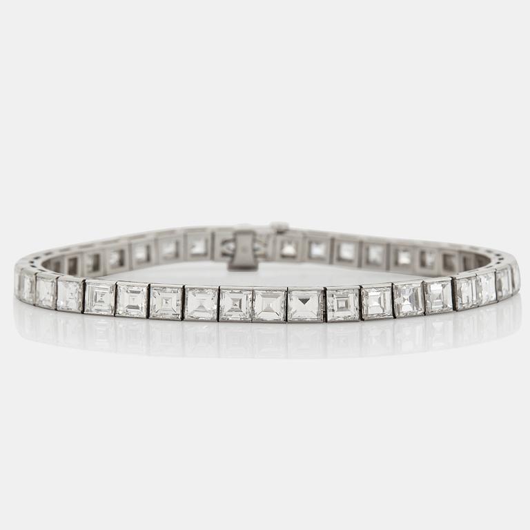 A platinum bracelet set with carré cut diamonds.