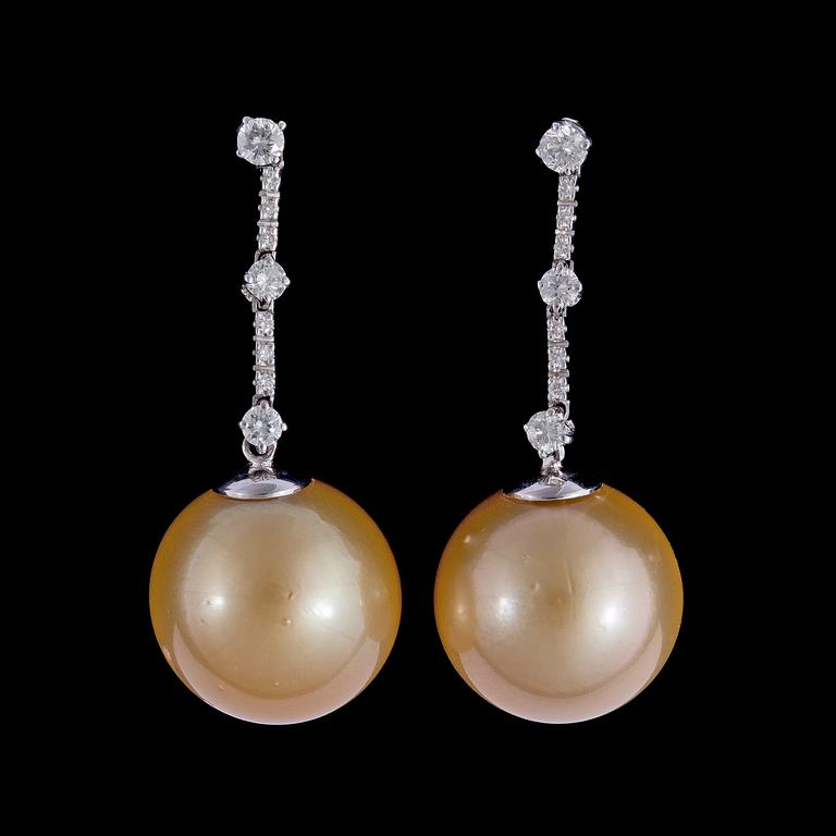 A pair of cultured golden South sea pearl, 15,8 mm, and brilliant cut diamond earrings, tot. 0.50 cts.