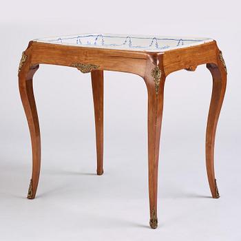 A rococo faience-top tea table, Rörstrand 1765.