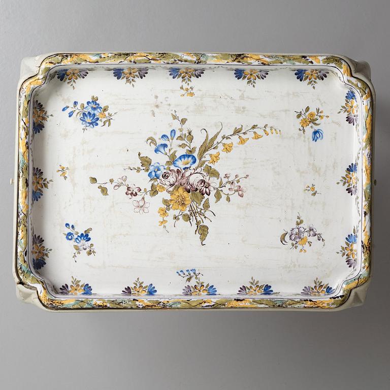 A Swedish Rococo faience tea table, dated 1774.