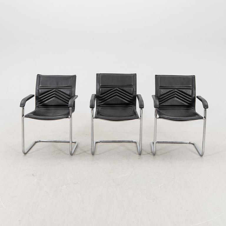 A set of five chrome and leather armchairs alter part of the 20th century.