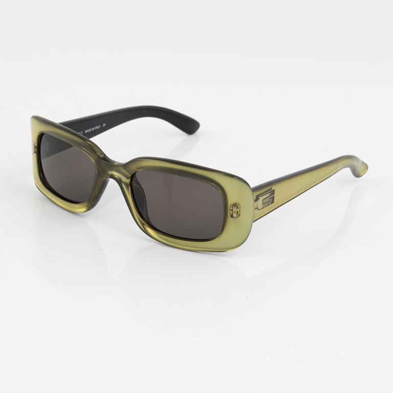 Gucci, a pair of green sunglasses.