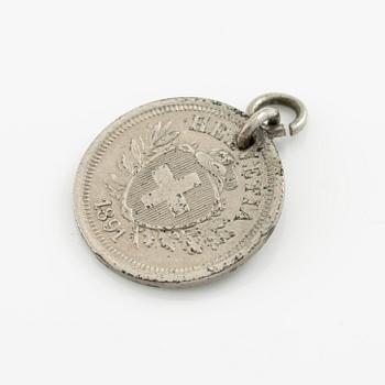 Two bracelets, a brooch, and a pendant with coins.