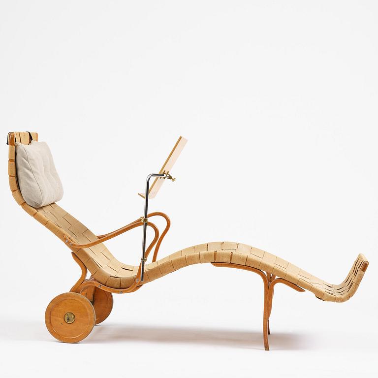 Bruno Mathsson, a lounge chair with wheels, Firma Karl Mathsson, Värnamo, 1940s, with reading table from 1972.
