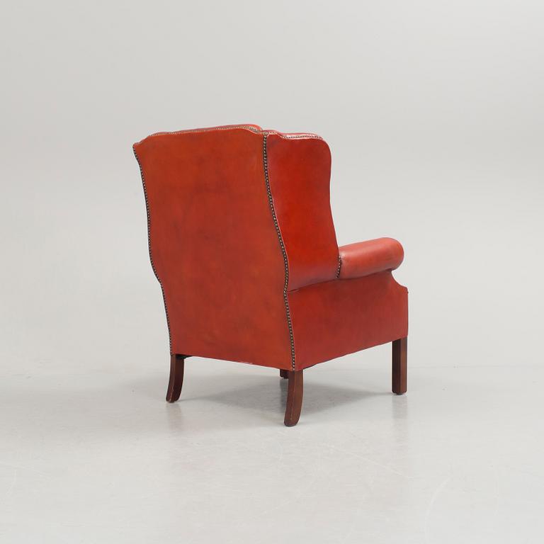 a 20h Century red lether armchair.