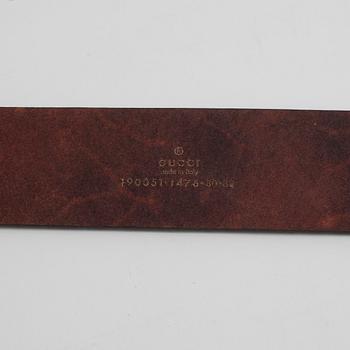 GUCCI, a brown monogram leather belt.
