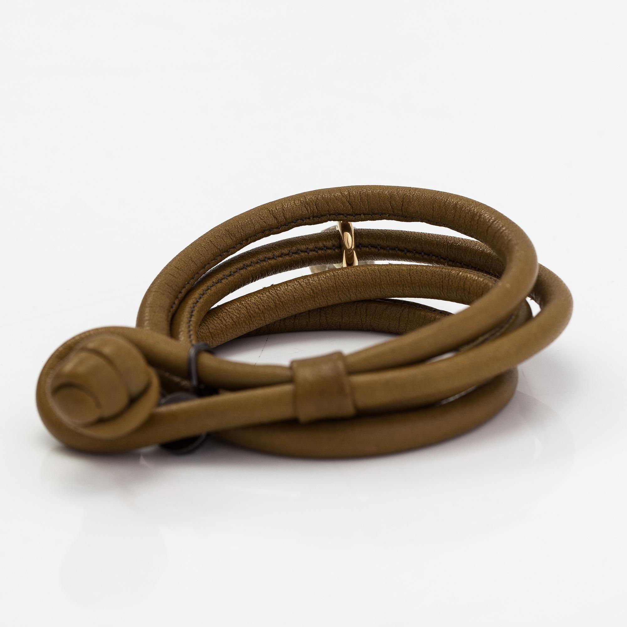 Ole Lynggaard, A 'Sweet drops' bracelet in leather with an 18K gold and green amethyst pendant. Denmark.