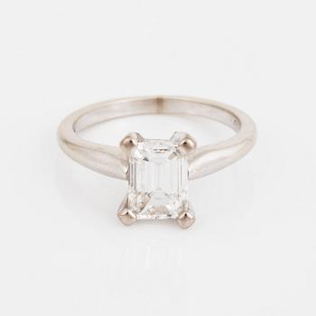 A solitiare emerald-cut diamond ring.