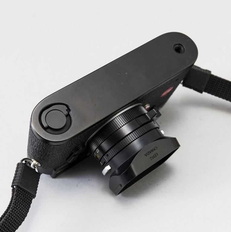 a black body Leica M4-P camera with no 1605951 made by Leitz Canada in 1982. With two lenses and a Leica Meter.