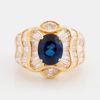 388. An 18K gold Junod ring set with a facted sapphire and tapered baguette-cut diamonds.