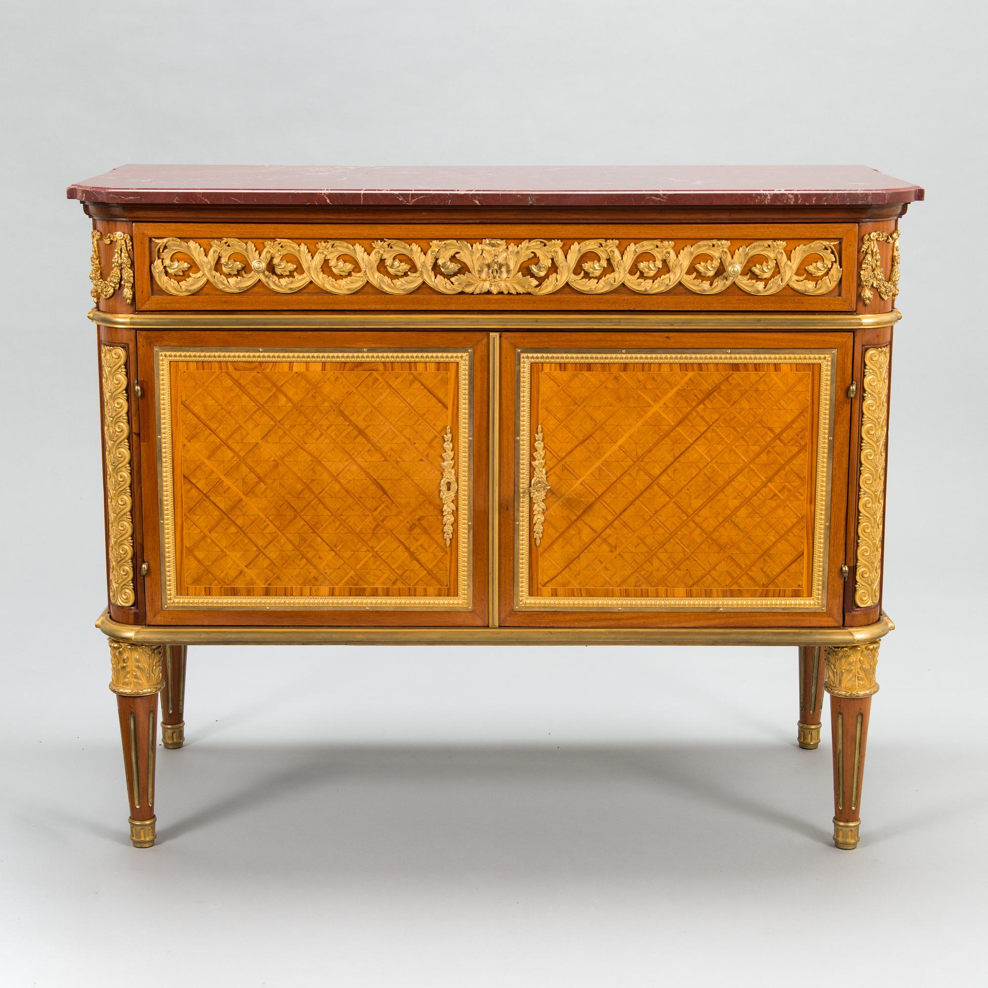 A French chest of drawer in Louis XVI style after Jean-Francois Leleu's school, late 19th century.