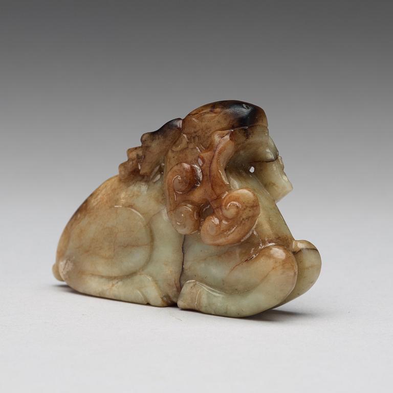 A carved nephrite figure of a reclining deer, late Qing dynasty.