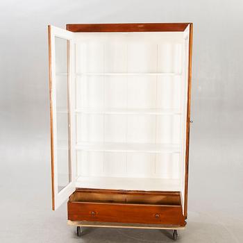 An early 1900s walnut display cabinet.