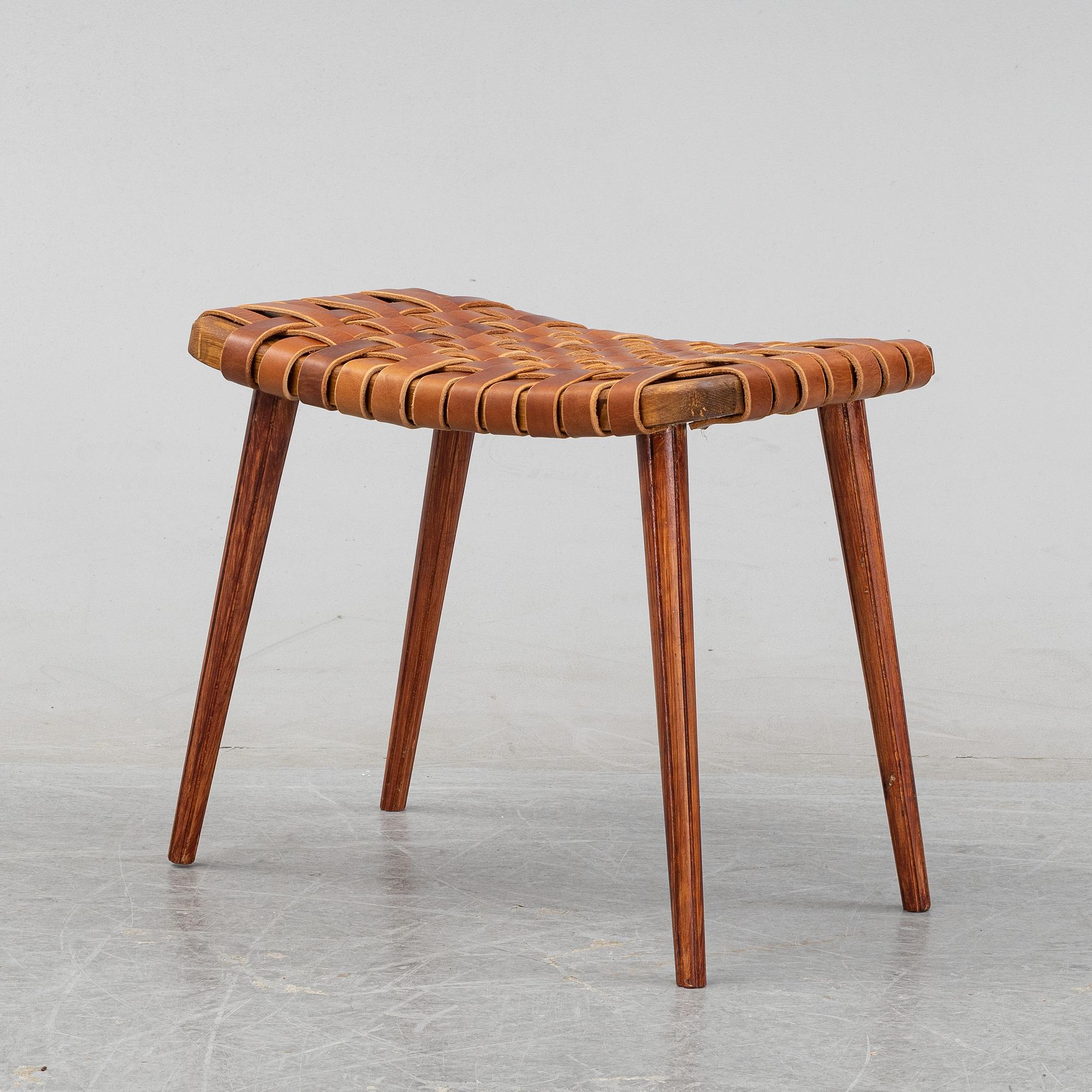 A leather upholstered stool, 1950's.