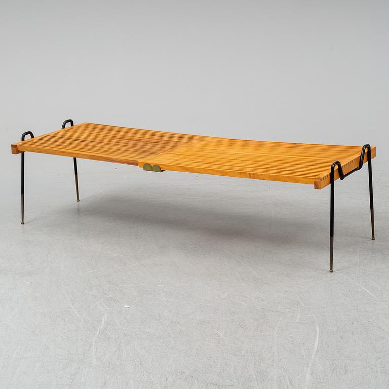 A mid 20th Century walnut extendible coffee table.