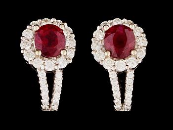 A pair of ruby and diamond earrings.