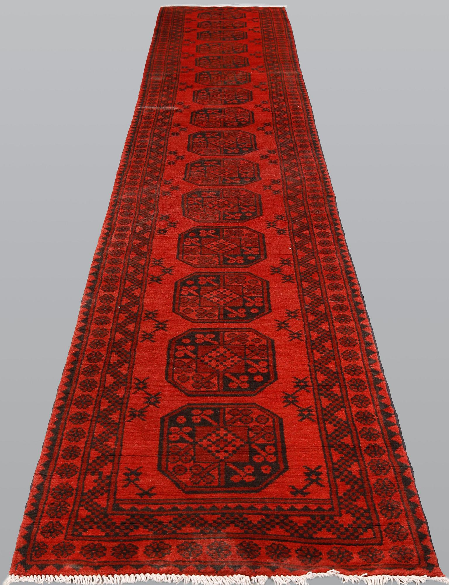 AnAfghan runner, ca 575 x 78 cm.
