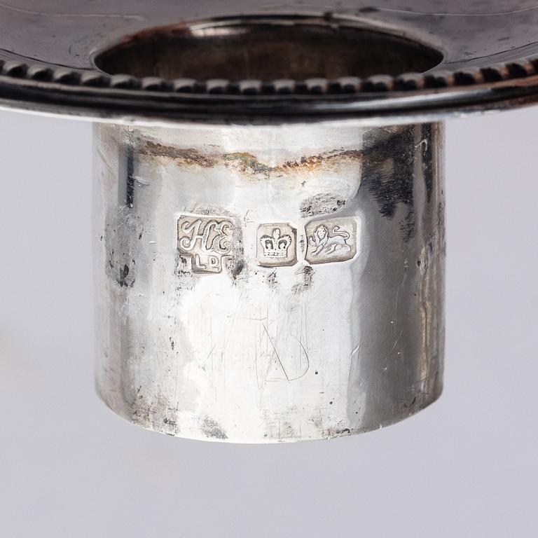 Four early 20th century silver candlesticks, marks of Hawksworth, Eyre & Co Ltd, Sheffield, England 1904-1906.