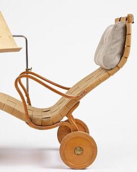 Bruno Mathsson, a lounge chair with wheels, Firma Karl Mathsson, Värnamo, 1940s, with reading table from 1972.