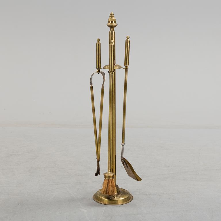 A set of 4 brass fire utensils with stand, 20th Century.