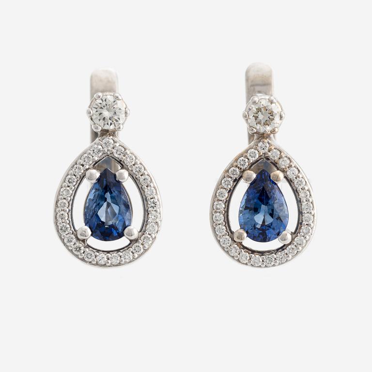 A pair of 14K gold earrings with faceted sapphires and round brilliant-cut diamonds.