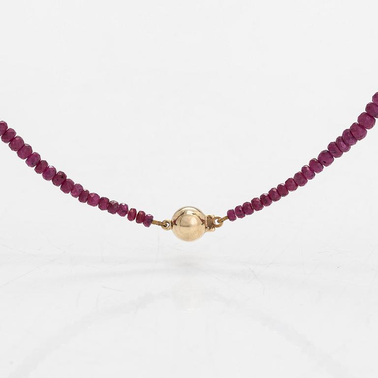 A necklace, set with rubies, clasp in 14K gold.