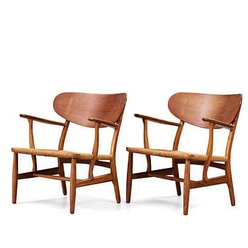 363. Hans J. Wegner, a pair of CH-22 oak and cord easy chairs, Carl Hansen & Son, Denmark, mid 20th century.