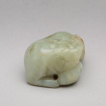 A nephrite figure of a reclining mythical beast, late Qing dynasty.