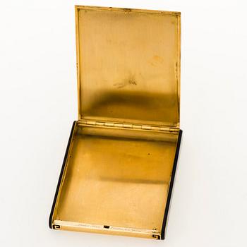A Cartier Art Deco cigarett case in 18K gold with black enamel.