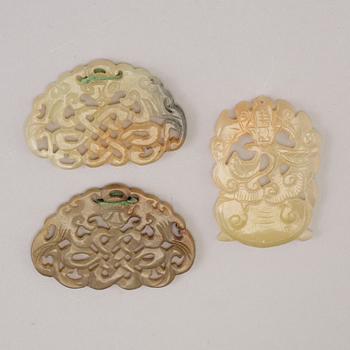 Three 20th century stone objects, with one bronze shield.