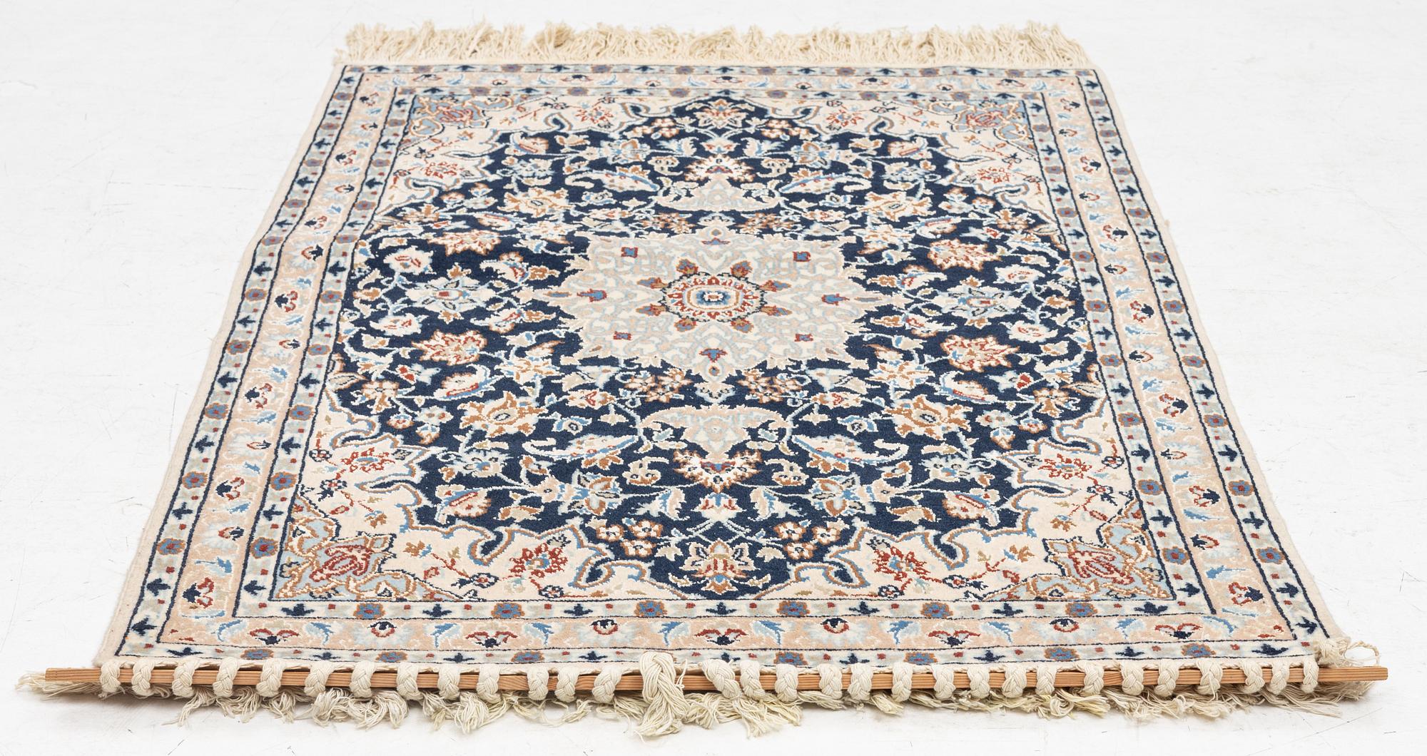A Nain rug, part silk, c. 128 x 82 cm.