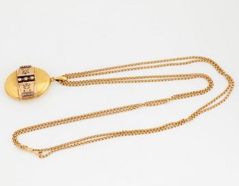 An 18K gold locket set with rose-cut diamonds.