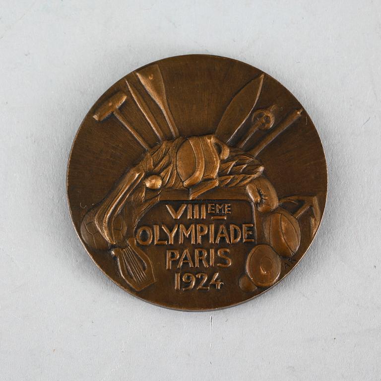 A third plaze bronze medal from the 1924 olympic games in Paris.