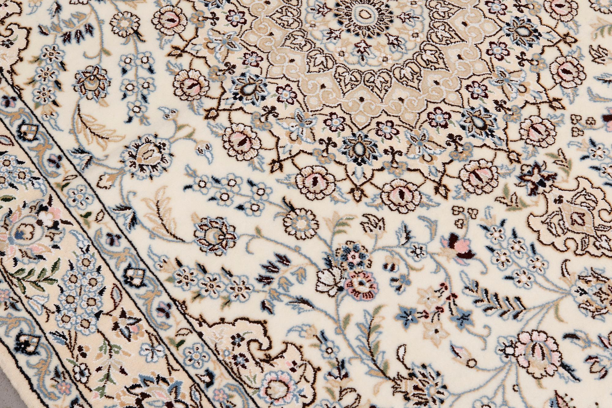 A Nain part silk carpet, 254 x 156 cm.