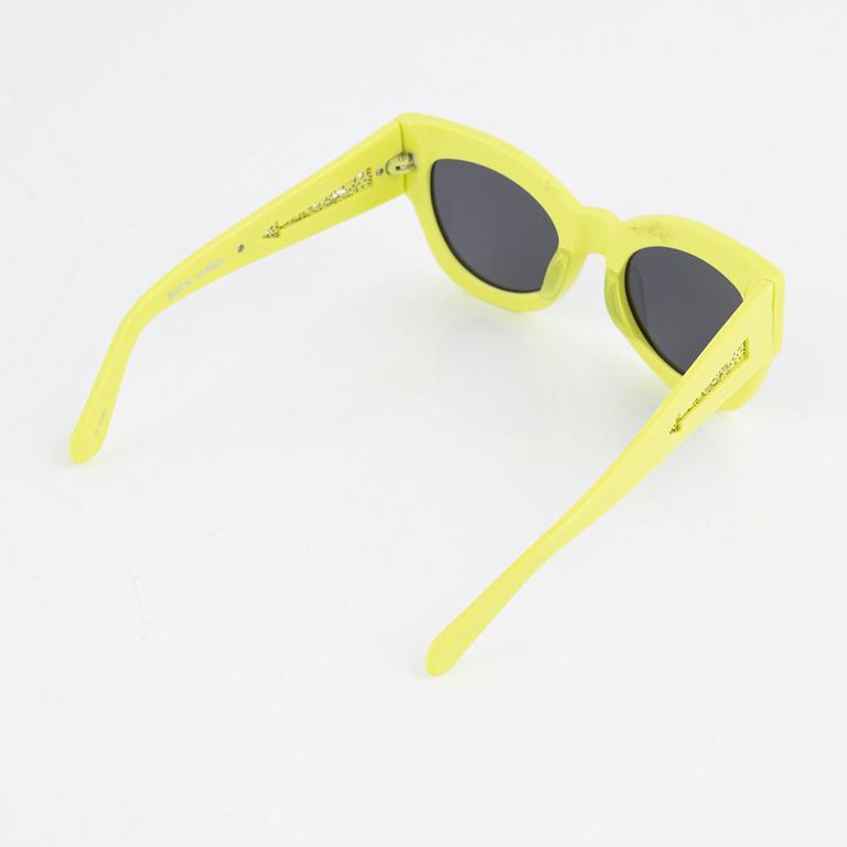 Karen Walker, a pair of neon green "Northern lights" sunglasses.