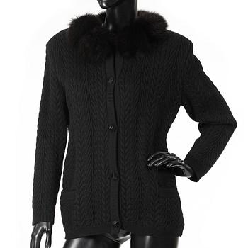 YVES SAINT LAURENT, a black cardigan with brown fox fur trimming.