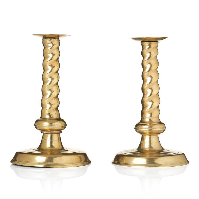 A pair of Northern European cast brass baroque candlesticks, circa 1700.