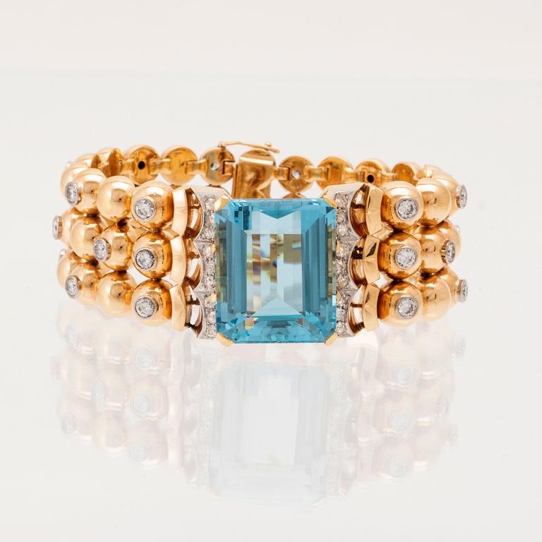 An 18K white and red gold bracelet set with rectangular step-cut aquamarine and round old-cut and brilliant-cut diamonds.