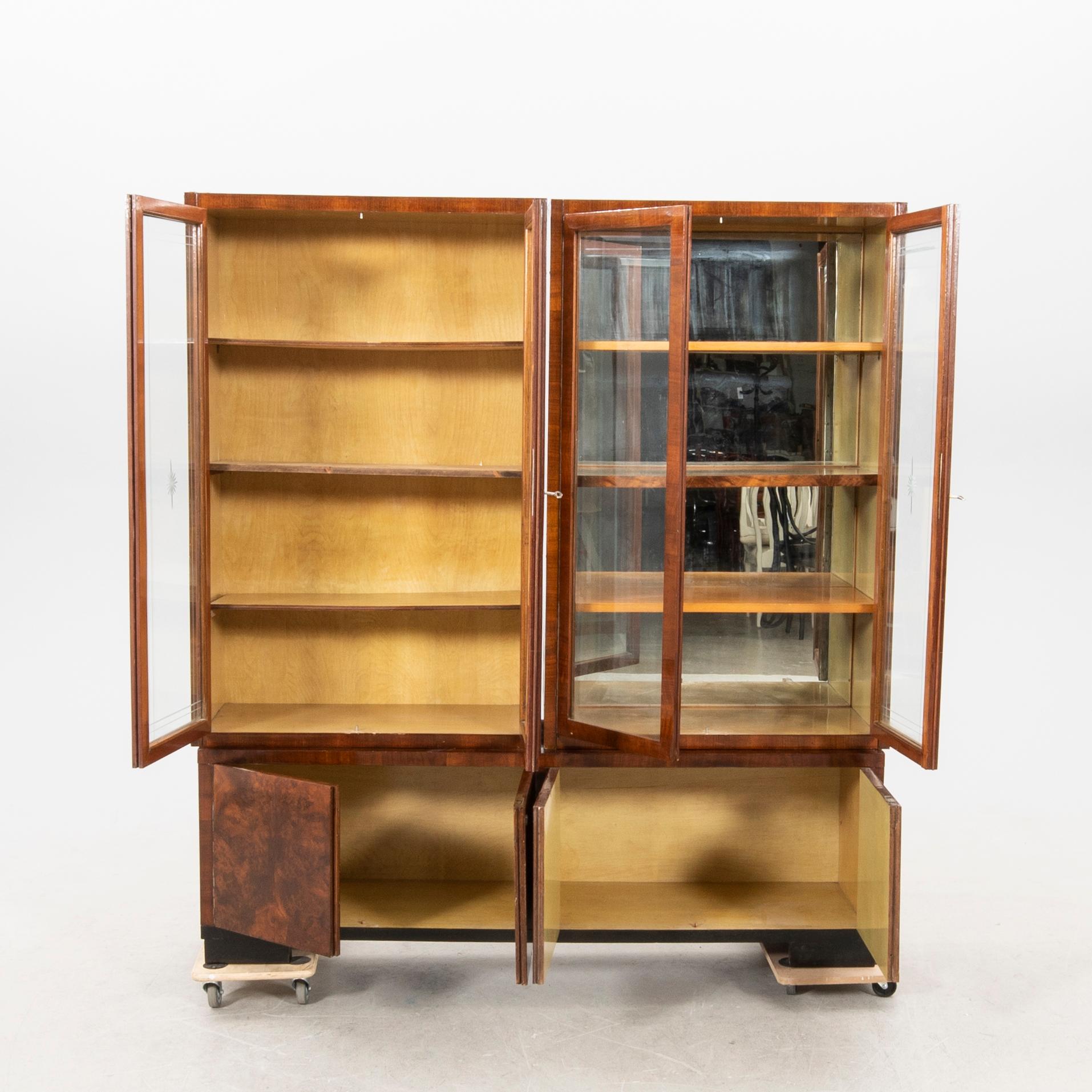 A stined walnut display cabinet from the first half of the 20th century.