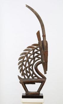 HEADDRESS. Tshiwara/Ciwara (stylized male antelope). Wooden sculpture with metal fittings.