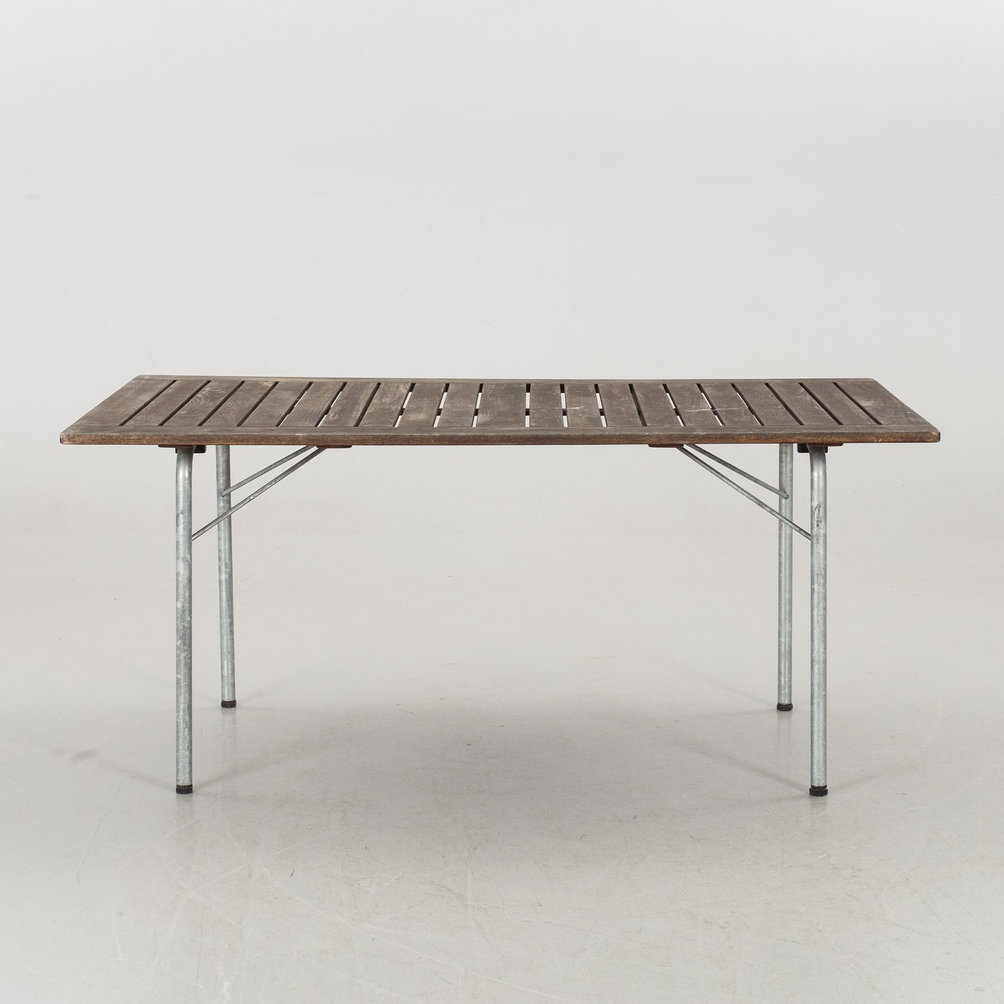 A GARDEN TABLE AND FOUR ARMCHAIRS FORM GRYTHYTTAN.