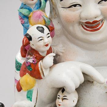 A Chinese porcelain laughing buddha with children, the 20th century.