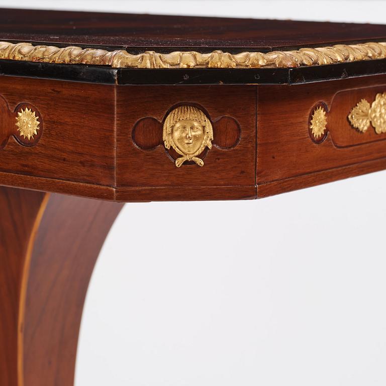 A north european Empire  'Umdruck'-decorated mahogny and gilded metal table.